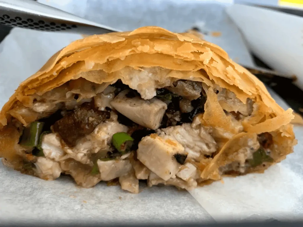 Chicken and mushroom filo parcel cut open to show the creamy filling inside flaky pastry