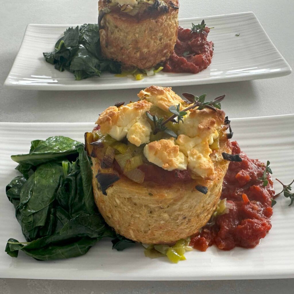 Baked hash brown cup topped with leek and feta, served with wilted spinach and tomato relish