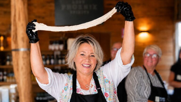 Stretching fresh pizza dough by hand at a Fleurieu class