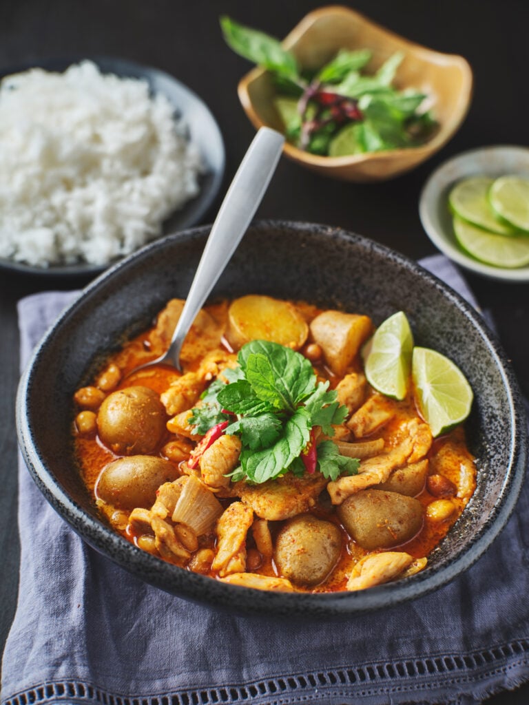 Thai massaman curry with chicken and potatoes, made from a paste ground from scratch, served with rice and lime