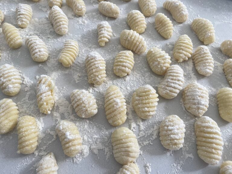 Hand-rolled ridged gnocchi resting on a floured bench